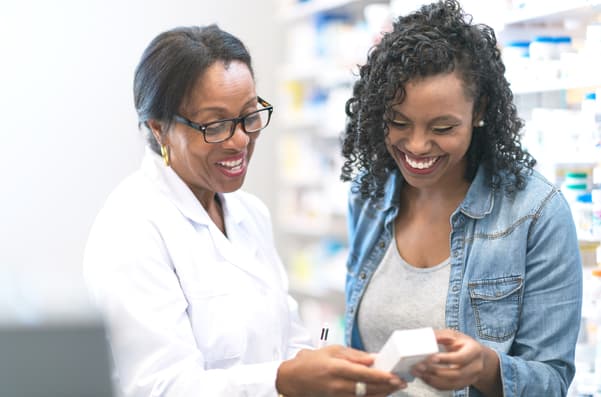 A pharmacist helping a customer with a prescription.