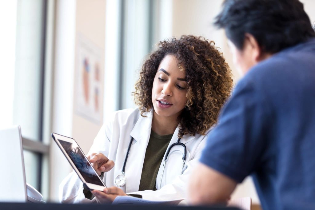 Pharmacist consulting with a tablet.