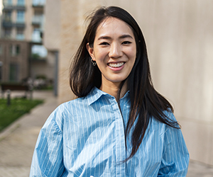 Woman smiling in a blue shirt.