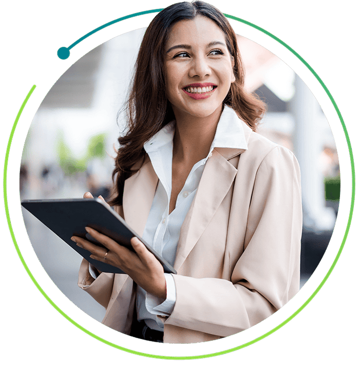 Smiling woman in a long coat with a tablet.